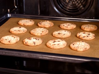 Baking tray with cookies in the oven.