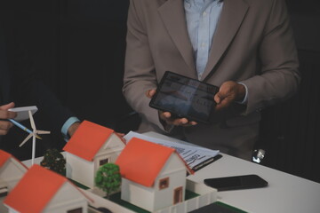 Hipster business man and Office building owner and energy engineer plan a project to build a solar panel for the building under construction. clean and green alternative energy concept.