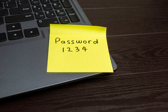 handwritten weak or simple password code sticky note on laptop keyboard. concept of password security management, strengthen password code