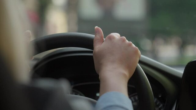 Unrecognizable woman girl female businesswoman driver automobile drive car in city traffic jam test driving auto school hold hands on steering wheel rent buy modern transport vehicle travel roadway