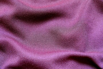 Viscose fabric of dark violet color. Knitted viscose pattern.