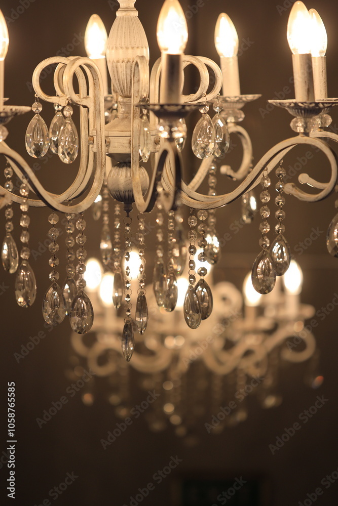 Poster a decorative lighting fixture with multiple lights suspended from above.