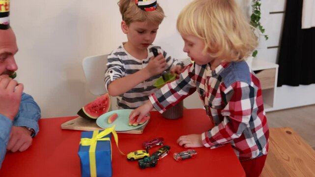 Dad and son celebrate a birthday together at home with cake and fun activities
