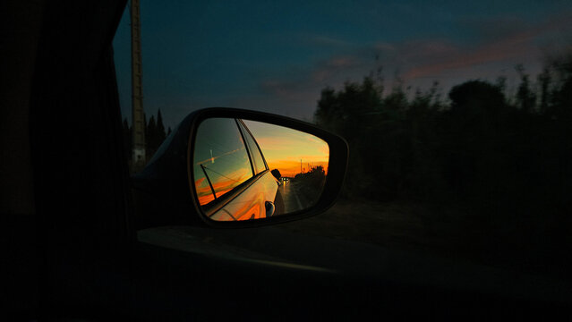 Sunset View In Side Mirror In Car Driving On The Road