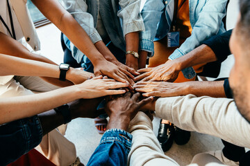 Teamwork concept with diverse hands joining together, symbolizing unity, cooperation, and...