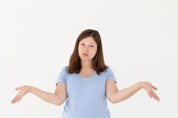 Confused thoughtful confused young woman holding copy space on palm over white background