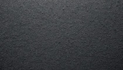 Textured black sandpaper surface, coarse grit, industrial backdrop, crafting material