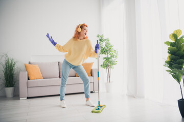 Photo of pretty cheerful lady wear yellow pullover headphones enjoying singing housekeeping indoors room home house