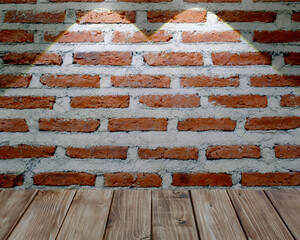 light beam shines on wood floor and brick wall