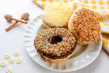 Donuts in white plate on white background