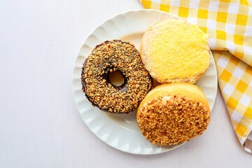 Donuts in white plate on white background