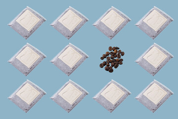 Rows of white paper sachets and coffee beans