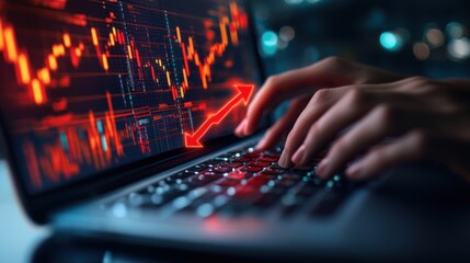 Laptop Displaying a Stock Market Graph and a Red Arrow