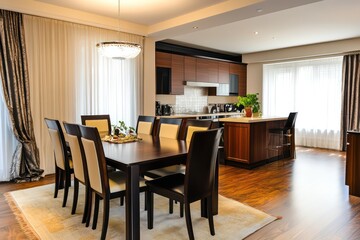 a dining room inside a luxurious residential apartment with a kitchennete in the background. 