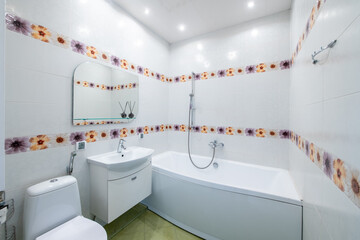 Bright Elegant Modern Luxury Home Bathroom Interior Design With White Sink. Mirror and Faucet. LED Lights. Shower Area, Tile Floor and Walls
