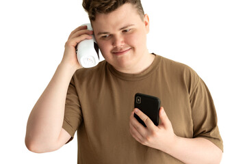 A young man is listening to music on a Bluetooth speaker from his phone.