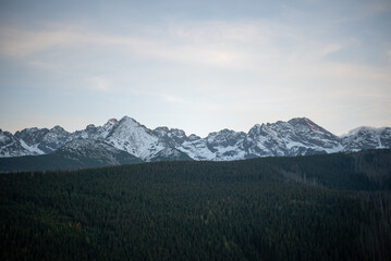 The sunset atop Mount Kopieniec in Zakopane, Poland, casts a warm glow over the Tatra Mountains
