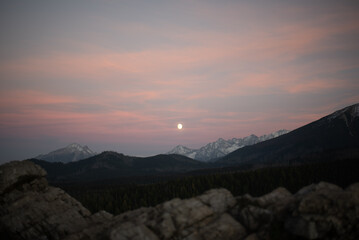 The sunset atop Mount Kopieniec in Zakopane, Poland, casts a warm glow over the Tatra Mountains