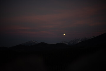 The sunset atop Mount Kopieniec in Zakopane, Poland, casts a warm glow over the Tatra Mountains, creating a stunning landscape