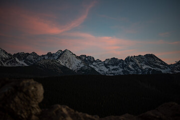 The sunset atop Mount Kopieniec in Zakopane, Poland, casts a warm glow over the Tatra Mountains, creating a stunning landscape