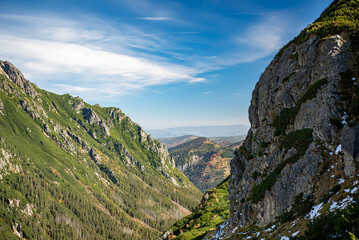 Obraz premium Unmatched mountain views in the Valley of Five Ponds, Tatra Mountains, Zakopane, Poland, reveal rugged peaks and alpine lakes, creating a breathtaking natural landscape