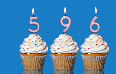 Birthday Cupcakes With Candles Lit Forming The Number 596