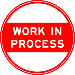 Red color round seal sticker in word work in process on white background
