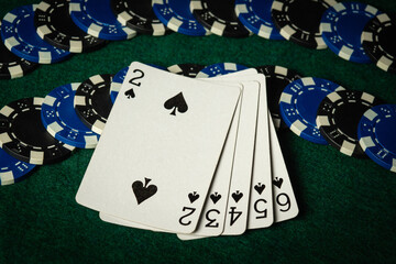 Playing cards layout on chips with a successful straight flush combination. Concept of winning a...