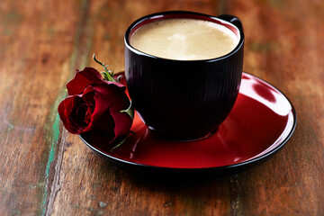 Cup of coffee on wooden background. Close up