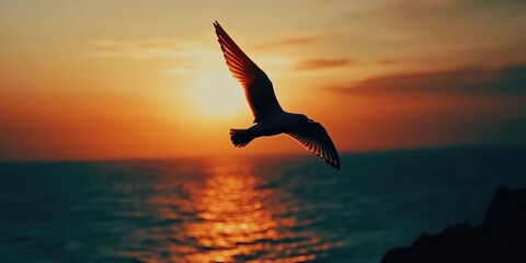 Fototapeta premium Bird Flying Over Ocean at Sunset