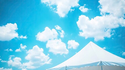 Low angle view of sections of a pristine white tent contrasting with a bright blue sky, ideal for capturing the essence of outdoor events with ample copy space.