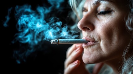 Obraz premium A striking portrait of a woman intensely savoring a cigarette, with deep focus on her face and swirls of blue smoke rising beautifully in the dark background.