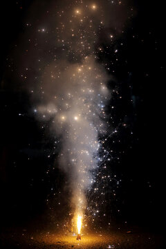 A vibrant sparkler bursts into life, lighting up the night with a dazzling shower of golden sparks.	