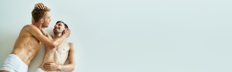 A young couple embraces closely, radiating love and warmth in a serene setting.