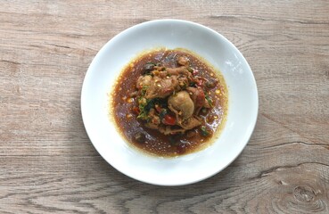 spicy chili stir-fried chicken meat and gizzard couple liver with basil leaf on plate