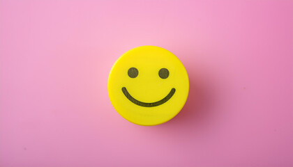 Fototapeta premium Smiling yellow face on pink background. Cheerful emotion. Feedback and customer satisfaction