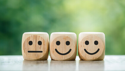 Wooden blocks with sad and happy emotions. Feedback and customer satisfaction concept.