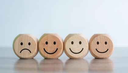 Wooden blocks with sad and happy emotions. Feedback and customer satisfaction concept.