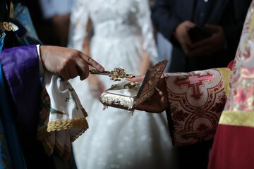 Traditional Armenian wedding ceremony with ornate religious artifacts and priestly garments