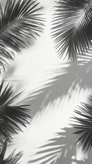 Fototapeta premium Black and white composition featuring palm leaves casting shadows on a plain background