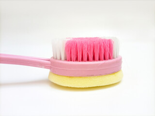 Bath brush and sponge made of plastic on white background, closeup, hygiene care shower brush with handle