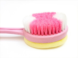 Bath brush and sponge made of plastic on white background, hygiene care shower brush with handle, close up