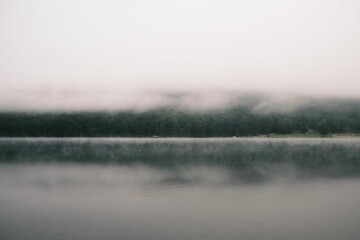 Fototapeta premium Serene lake with misty reflection