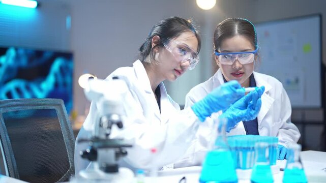 Two scientists working with test tubes in laboratory