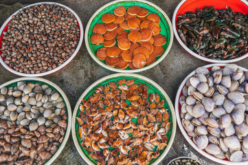 A variety of Fresh edible oysters, clams and scallops at the local market in Nha Trang, Vietnam.