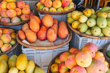 Various mango varieties are stored for sale on the market in Asia.
