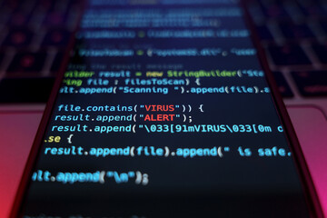 Virus on smartphone device. Programming code with Virus alert input. Malware and security online concept