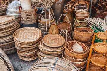 A set of handmade traditional Asian baskets made of straw and natural fiber for sale at the outdoor market in Nha Trang