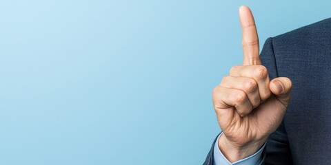 A business professional raising their index finger in a gesture of importance, against a soft blue background.