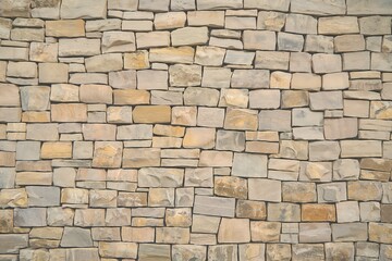 Obraz premium a close-up view of a wall constructed using irregularly shaped stones